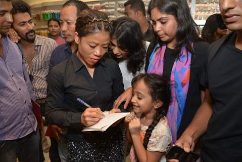 Mary Kom signs an autograph for a young fan at The Hab promoted by Usha International