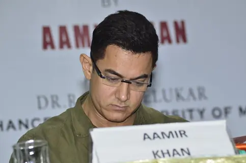 Aamir Khan goes through the Communicative Marathi Book at the Launch