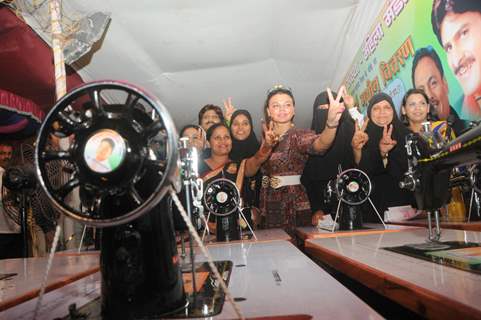 Rakhi Sawant poses with sewing machines at the event