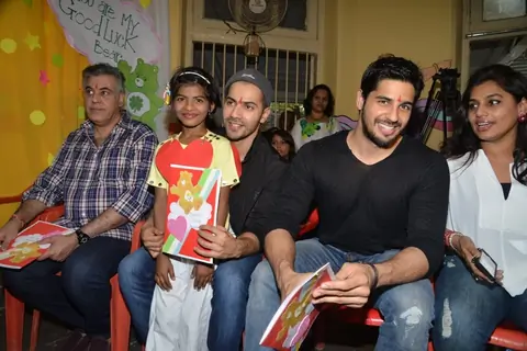 Varun Dhawan and Sidharth Malhotra pose with a kid at Ashray Ngo