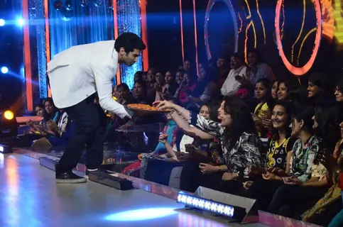 Aditya Roy Kapur distributes sweets to the audience on Jhalak Dikhhlaa Jaa