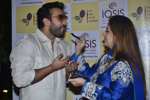 A guest feeds Raj Kundra a piece of cake at the Promotion of Iosis Medi Spa