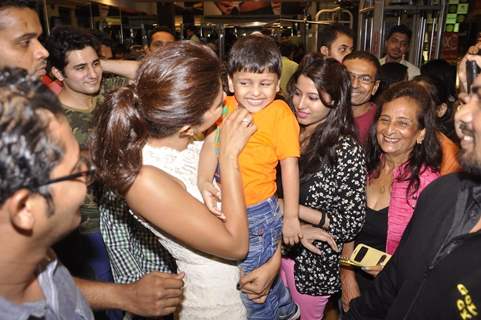 Priyanka Chopra plays with a kid at the Promotions of Mary Kom at Gold's Gym