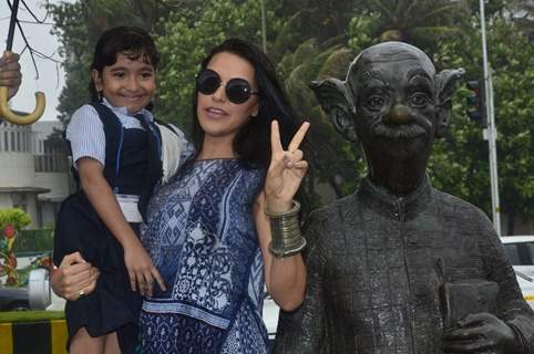 Neha Dhupia clicks a picture with a young fan