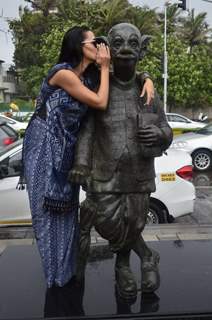Neha Dhupia says a secret to the comman man's statue of R.K. Laxman