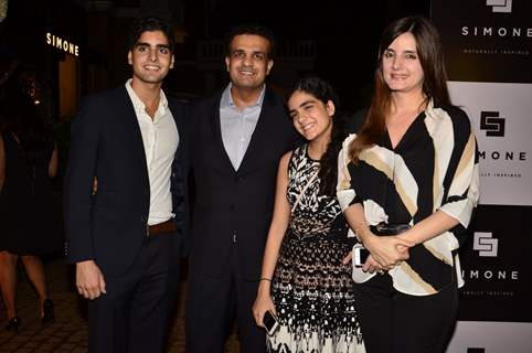 Simone Khan poses with her husband and children at her Store Launch