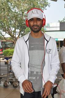 Dhanush poses for the media at Airport