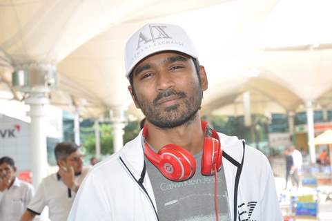 Dhanush poses for the media at Airport