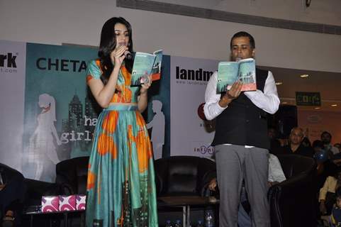 Kriti Sanon and Chetan Bhagat reading the book at the Book Launch of Half Girlfriend