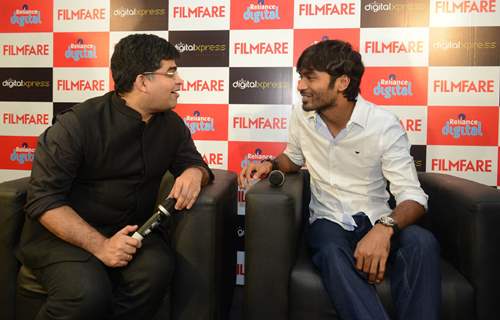 Dhanush chats with Jitesh Pillai at the Filmfare Readers Meet at the Reliance Digital Store