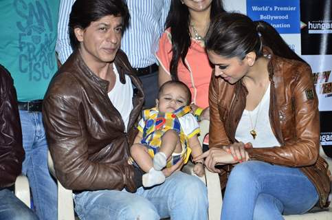 Shahrukh Khan with a baby fan at the Happy New Year Event