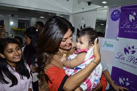 Sushmita Sen plays with a kid at Dr. Trasi's Clinic Launch