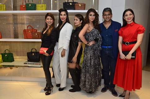 Celebs pose for the media at Michael Korrs Store Launch