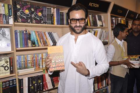 Saif Ali Khan poses with a book at the Promotions of Happy Ending