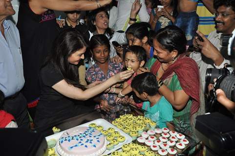 Aishwarya Rai Bachchan feed cake to Children at Smile Train Organisation