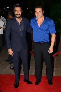 Ajay Devgn and Sohail Khan pose for the media at Arpita Khan's Wedding Reception