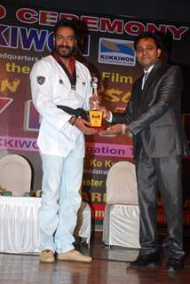 Ajay Devgn felicitated with a Trophy by Taekwondo Masters from Korea