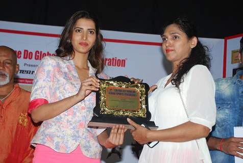 Manasvi Mamgai giving an award to a winner at Chita Jeet Kune Do Global Sports Acadamy