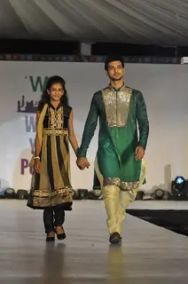 Shakti Arora walks the ramp with a small girl at Wellingkar's 26/11 Tribute