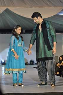 Viraf Phiroz Patel walks the ramp with a small girl at Wellingkar's 26/11 Tribute