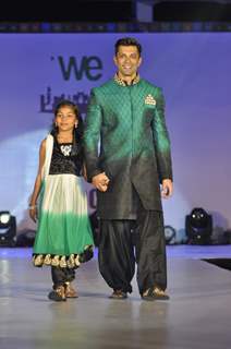 Karan Singh Grover walks the ramp with a small girl at Wellingkar's 26/11 Tribute