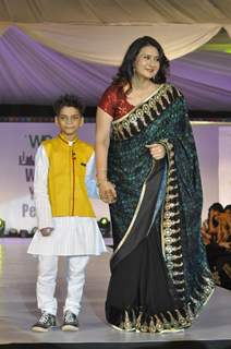 Poonam Dhillon walks the ramp with a small boy at Wellingkar's 26/11 Tribute