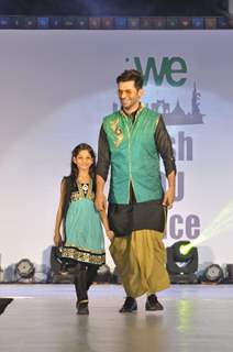 Sunil Grover walks the ramp with a small girl at Wellingkar's 26/11 Tribute