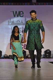 Jay Soni walks the ramp with a small girl at Wellingkar's 26/11 Tribute