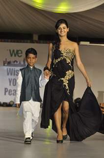 Shakti Mohan walks the ramp with a small boy at Wellingkar's 26/11 Tribute