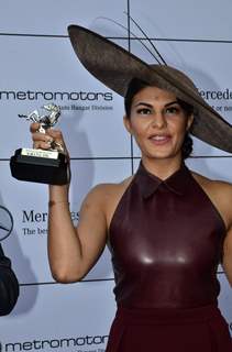 Jacqueline Fernandes holds up her momento at the Metro Motors Auto Hangar Race
