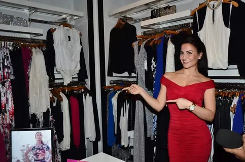 Elli Avram points out at the designs at the bebe Store