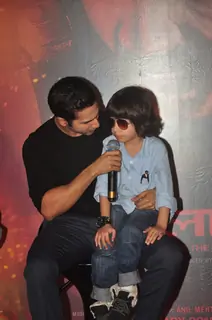 Varun Dhawan interacts with a young fan at the Trailer Launch of Badlapur