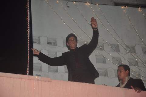 Shah Rukh Khan climbs the wall at Maratha Mandir and waves to his fans during the Celebration