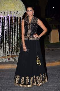 Neha Dhupia poses for the media at the Wedding Reception of Riddhi Malhotra and Tejas Talwalkar