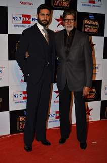 Abhishek Bachchan and Amitabh Bachchan pose for the media at Big Star Entertainment Awards 2014