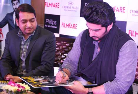 Arjun Kapoor signs his autograph on the Latest Issue of Filmfare Magazine