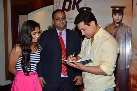 Aamir Khan signs an autograph for a fan at P.K. Contest Winners Meet