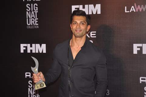 Karan Singh Grover poses with his award at FHM Bachelor of the Year Bash