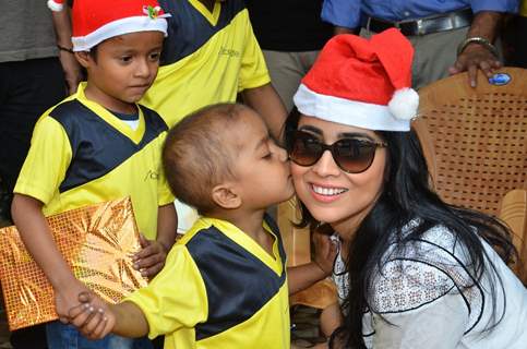 A small kid gives Shriya Saran a kiss at the Christmas Celebration
