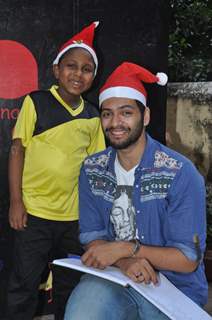 Ali Fazal poses with a Ngo Kid at the Christmas Celebrations