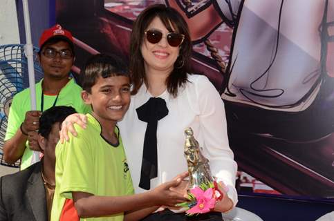 Amrita Raichand poses with a kid at the Special Christmas Treat for Underprivileged Children