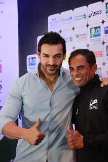 John Abraham poses with a sports person at SCMM Marathon Meet