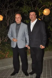 Anupam Kher and Anu Malik pose for the media at Farah Khan's Birthday Bash
