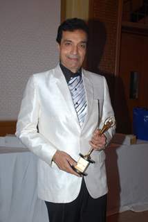 Dhiraj Kumar poses with his award at the Golden Achiever Awards