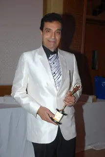 Dhiraj Kumar poses with his award at the Golden Achiever Awards