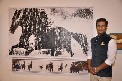 Randeep Hooda poses for the media at an Art Exhibition