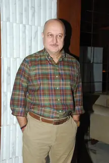 Anupam Kher poses for the media at Arya Babbar's Book Launch