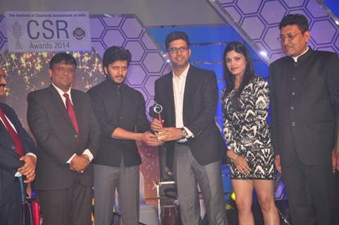 Riteish Deshmukh receives an award at CSR Awards