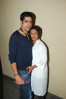 Murli Sharma and Ashwini Kalsekar pose for the media at the Special Screening of Badlapur