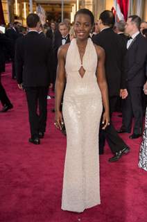 Lupita Nyong'o poses for the media at the Oscars Red Carpet 2015